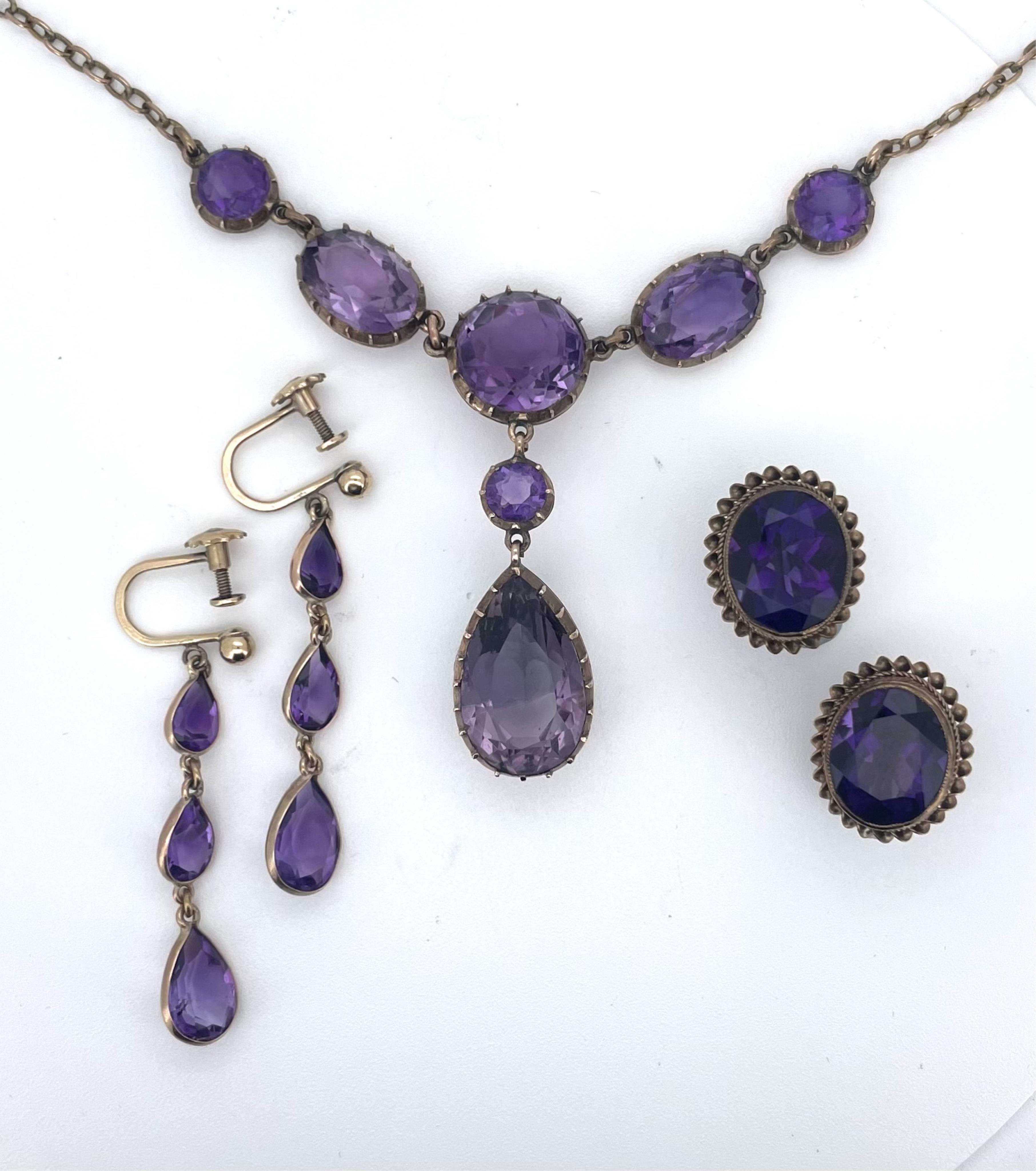 An amethyst necklace and two pairs of earrings, comprising: a Victorian necklace, the front composed of circular-cut and oval amethysts in pinched collet settings, suspending a pear-shaped amethyst pendant, to a plain go
